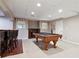 Finished basement with a pool table, bar area with seating, and a drop ceiling at 4310 Wellbrook Ct, Douglasville, GA 30135