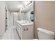 Well-lit bathroom featuring a double vanity, white tile floor, and shower with sliding glass doors at 4310 Wellbrook Ct, Douglasville, GA 30135