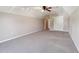 An additional angle of this bedroom featuring gray carpet, a ceiling fan, and closet doors at 4310 Wellbrook Ct, Douglasville, GA 30135
