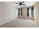 Cozy carpeted bedroom featuring two windows with black curtains and a ceiling fan at 4310 Wellbrook Ct, Douglasville, GA 30135
