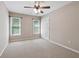Well-lit bedroom with gray carpet, closet, and two windows providing natural light at 4310 Wellbrook Ct, Douglasville, GA 30135