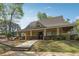 Exterior view of a clubhouse with covered seating and green landscaping, offering a community gathering space at 4310 Wellbrook Ct, Douglasville, GA 30135