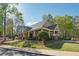 Exterior view of the community clubhouse featuring a covered porch, brick accents, and manicured landscaping at 4310 Wellbrook Ct, Douglasville, GA 30135