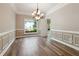 A dining room featuring elegant trim work, modern chandelier, and wood flooring at 4310 Wellbrook Ct, Douglasville, GA 30135