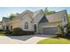 Charming stucco home with a two-car garage, complemented by lush landscaping and a well-maintained lawn at 4310 Wellbrook Ct, Douglasville, GA 30135