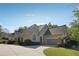Charming stucco home with a two-car garage, complemented by lush landscaping and a well-maintained lawn at 4310 Wellbrook Ct, Douglasville, GA 30135