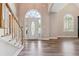 Elegant foyer with beautiful front door, hardwood floors, and a staircase for a grand entrance at 4310 Wellbrook Ct, Douglasville, GA 30135