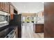 Well-lit kitchen with modern appliances and center island opens to the breakfast nook with views of the landscaped yard at 4310 Wellbrook Ct, Douglasville, GA 30135
