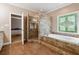 Beautiful main bathroom with custom tiled shower, soaking tub, and decorative window for a luxurious feel at 4310 Wellbrook Ct, Douglasville, GA 30135