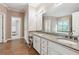 Bright and spacious main bathroom with double sinks, granite counters, soaking tub, and tile flooring at 4310 Wellbrook Ct, Douglasville, GA 30135
