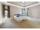 Spacious main bedroom with neutral decor, carpet, ceiling fan, and large windows for natural light at 4310 Wellbrook Ct, Douglasville, GA 30135