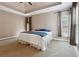 Large main bedroom with tray ceiling and several windows for natural light, decorated with soothing neutral colors at 4310 Wellbrook Ct, Douglasville, GA 30135