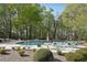 Community pool with lounge chairs, sun umbrellas, and lush landscaping, providing a relaxing atmosphere at 4310 Wellbrook Ct, Douglasville, GA 30135