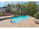 Backyard oasis featuring a sparkling pool, hot tub, and ample lounge space for outdoor enjoyment at 4310 Wellbrook Ct, Douglasville, GA 30135