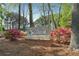 Community signage for a swim and tennis club surrounded by colorful azaleas, nestled among mature trees at 4310 Wellbrook Ct, Douglasville, GA 30135