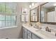Bathroom with double vanity sinks, framed mirrors, and window at 1226 Haven Brook Ne Way, Brookhaven, GA 30319