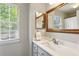 Bathroom featuring framed mirror and a window at 1226 Haven Brook Ne Way, Brookhaven, GA 30319