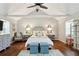 Bright bedroom with vaulted ceilings, hardwood floors, sitting area, and two upholstered storage ottomans at 1226 Haven Brook Ne Way, Brookhaven, GA 30319