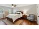 Bedroom with hardwood floors, chair, side table, and dresser at 1226 Haven Brook Ne Way, Brookhaven, GA 30319
