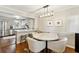 Dining area featuring hardwood floors, a marble table, stylish chairs, and modern lighting at 1226 Haven Brook Ne Way, Brookhaven, GA 30319