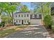 Charming two-story home featuring a black door, an attached two-car garage, and a well-manicured lawn at 1226 Haven Brook Ne Way, Brookhaven, GA 30319