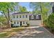 Charming two-story home featuring a black door, an attached two-car garage, and a well-manicured lawn at 1226 Haven Brook Ne Way, Brookhaven, GA 30319