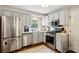 Updated kitchen with stainless steel appliances, white subway tile backsplash, and gray cabinets at 1226 Haven Brook Ne Way, Brookhaven, GA 30319