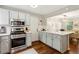 Updated kitchen with stainless appliances, light gray cabinetry, and an open layout to dining area at 1226 Haven Brook Ne Way, Brookhaven, GA 30319