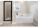 Bright bathroom with a tub and a glass-enclosed shower showcasing modern design at 1902 Glen Ivy, Marietta, GA 30062