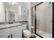 Modern bathroom with sleek black framed glass shower, white cabinets, and granite countertop, offering stylish functionality at 1902 Glen Ivy, Marietta, GA 30062