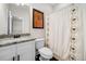 Bathroom featuring white cabinets, granite countertop, modern fixtures and decorated mirror at 1902 Glen Ivy, Marietta, GA 30062
