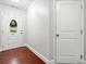 Bright foyer with hardwood floors, white door with oval glass insert and paneled interior door at 1902 Glen Ivy, Marietta, GA 30062
