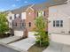 A row of townhomes with brick and siding exteriors, each with an attached garage and driveway at 1902 Glen Ivy, Marietta, GA 30062