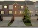Exterior shot of brick townhomes showcasing the facade and attached garages at 1902 Glen Ivy, Marietta, GA 30062