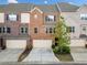 Charming brick townhome featuring an attached one-car garage and well-maintained landscaping at 1902 Glen Ivy, Marietta, GA 30062
