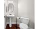 Cozy half bathroom with pedestal sink, hardwood floors and modern fixtures at 1902 Glen Ivy, Marietta, GA 30062