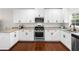 A kitchen showcases white cabinets, stainless steel appliances, granite countertops, and hardwood floors at 1902 Glen Ivy, Marietta, GA 30062