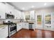 Bright kitchen with white cabinets, granite countertops, stainless steel appliances, and French doors at 1902 Glen Ivy, Marietta, GA 30062