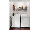 A laundry room equipped with a washer, a dryer, and a shelf above at 1902 Glen Ivy, Marietta, GA 30062