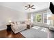 Cozy living room with hardwood floors, plush sectional, fireplace, and large windows at 1902 Glen Ivy, Marietta, GA 30062