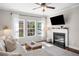 Comfortable living room with fireplace, large windows, stylish décor, and hardwood floors at 1902 Glen Ivy, Marietta, GA 30062