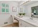 Bright bathroom with a vanity area, large mirror, and plantation shutters at 5245 Cherry Hill Ln, Powder Springs, GA 30127