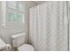 Bathroom with a tile floor and geometric-patterned shower curtain at 5245 Cherry Hill Ln, Powder Springs, GA 30127