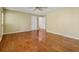 Spacious bedroom featuring hardwood floor, neutral walls, ceiling fan, and two doors at 5245 Cherry Hill Ln, Powder Springs, GA 30127