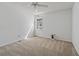 Neutral bedroom with a ceiling fan, light-colored carpet, and a window providing natural light at 5245 Cherry Hill Ln, Powder Springs, GA 30127