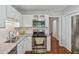 Well-lit kitchen features stainless steel appliances, granite countertops, and white cabinets at 5245 Cherry Hill Ln, Powder Springs, GA 30127
