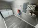 Convenient laundry room with washer, dryer, storage shelving, and gray flooring at 5245 Cherry Hill Ln, Powder Springs, GA 30127