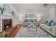 Cozy living room showcasing a fireplace, a large window, and comfortable seating at 5245 Cherry Hill Ln, Powder Springs, GA 30127