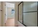 Bathroom featuring modern tile shower, dark hardware, and view to adjoining bedroom at 553 Somersby Dr, Dallas, GA 30157