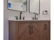Close up of bathroom vanity featuring double sinks, modern fixtures, wood cabinets and white countertop at 553 Somersby Dr, Dallas, GA 30157